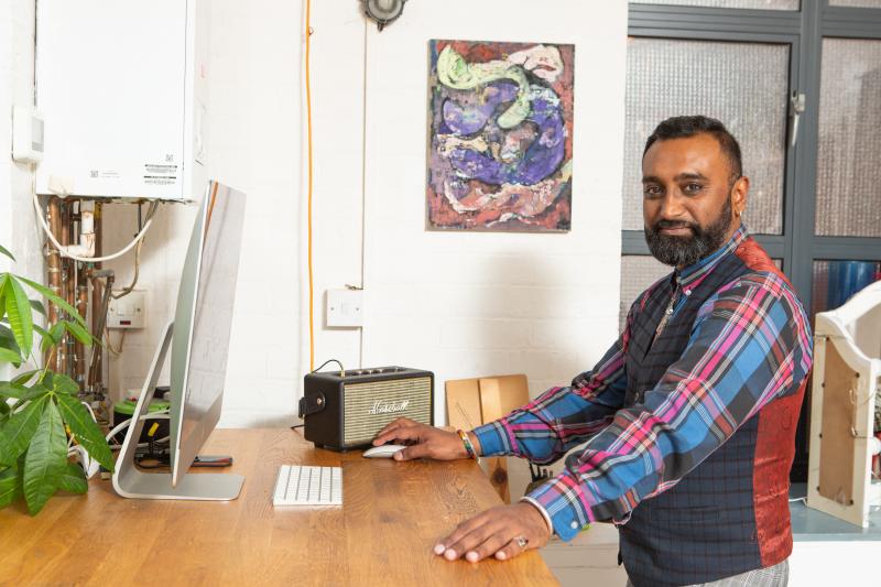 Person standing at a computer.